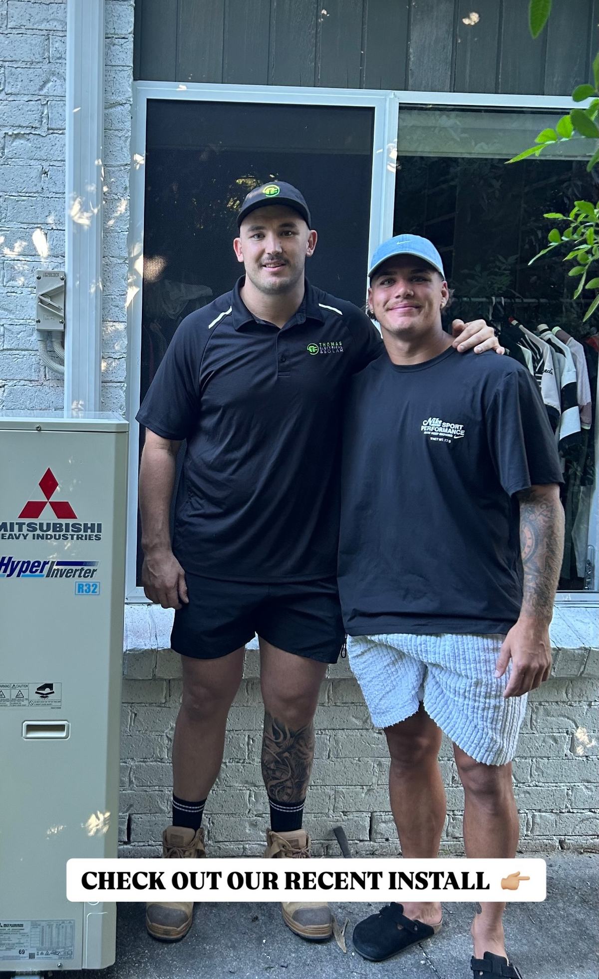 Bryce from Thomas Electrical and Solar standing with Reece Walsh in front of a newly installed air conditioning unit
